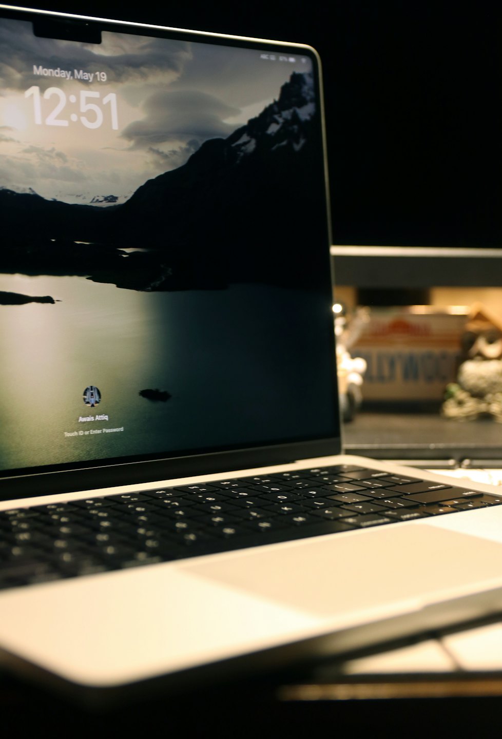 Laptop d'argento con uno sfondo di paesaggio montano sullo schermo.